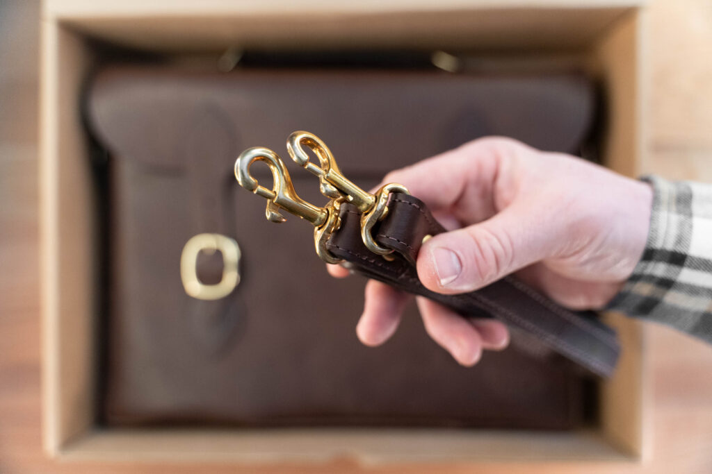 Solid Brass Clips On The Detachable Leather Shoulder Strap. Solid Brass Clips On The Detachable Leather Shoulder Strap.