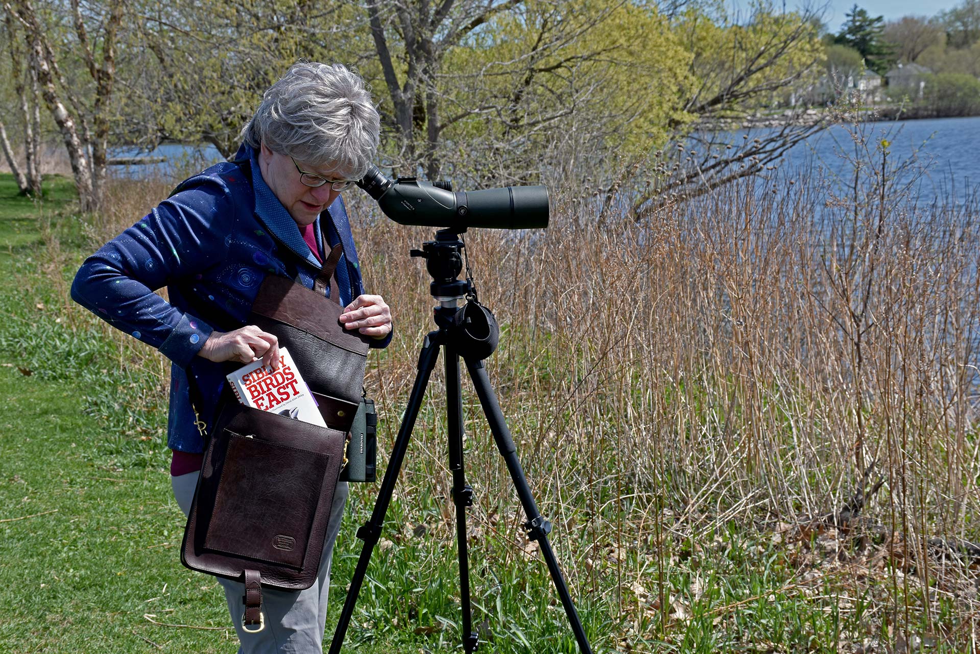 Naturalist Using Expedition Bag For Birding Naturalist Using Expedition Bag For Birding