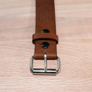 A 1.5 inch wide whiskey tan full grain leather belt with steel roller buckle