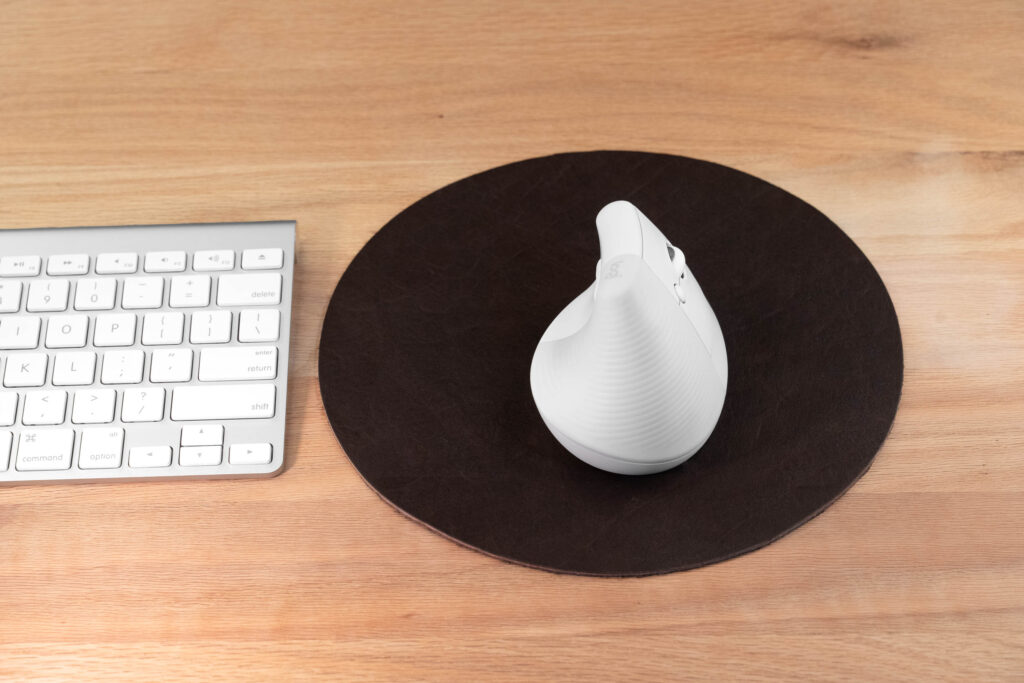 Brown Round Leather Mouse Pad Next To Apple Keyboard Brown Round Leather Mouse Pad Next To Apple Keyboard