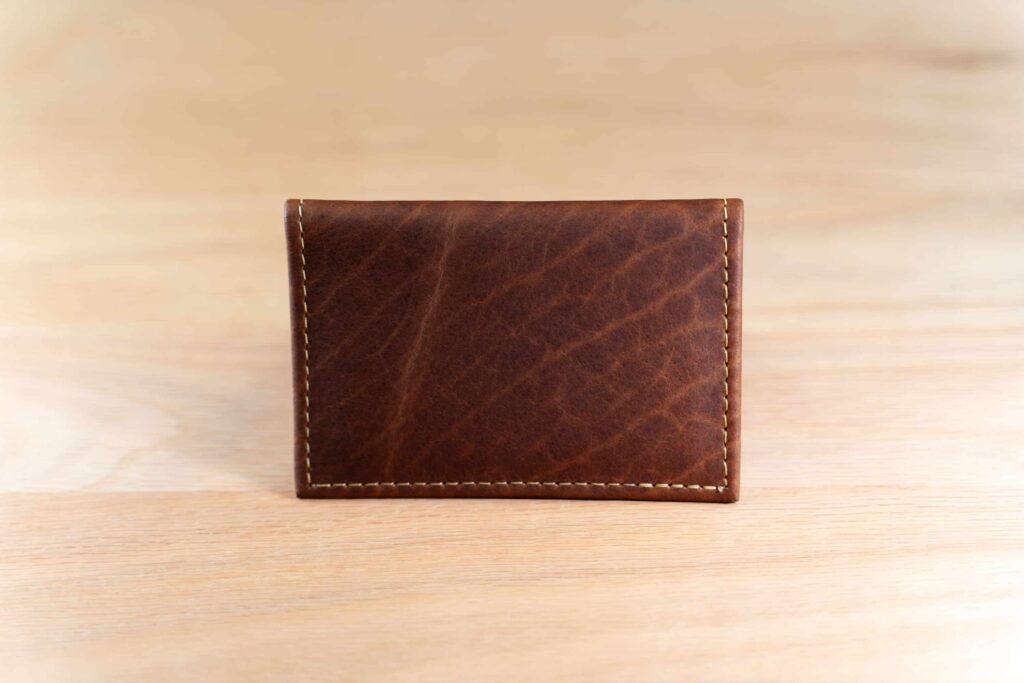 Showing The Full-Grain American Bison Leather Of The American Chestnut Bifold Leather Card Holder With Id Showing The Full-Grain American Bison Leather Of The American Chestnut Bifold Leather Card Holder With Id