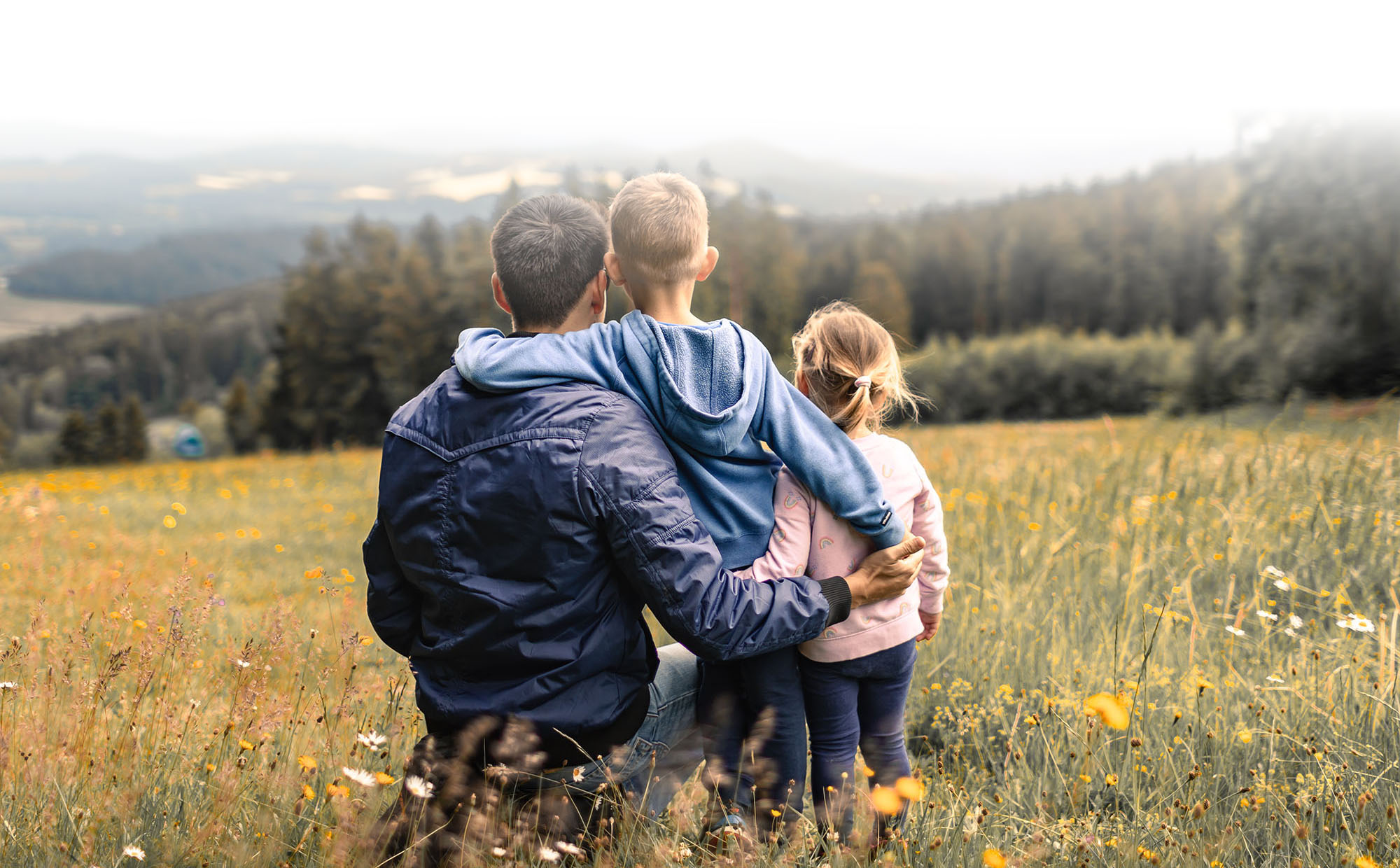 Dad And Kids Enjoying Nature In A Field Dad And Kids Enjoying Nature In A Field